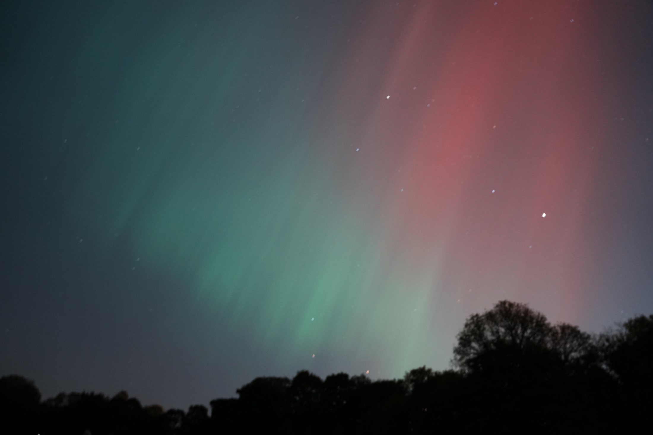 Aurora over a dark landscape